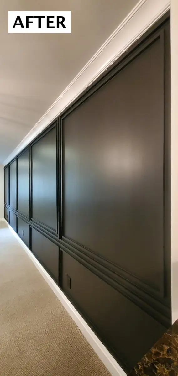 The same hallway after: panel moulding and walls in deep green-black with white crown and baseboard
